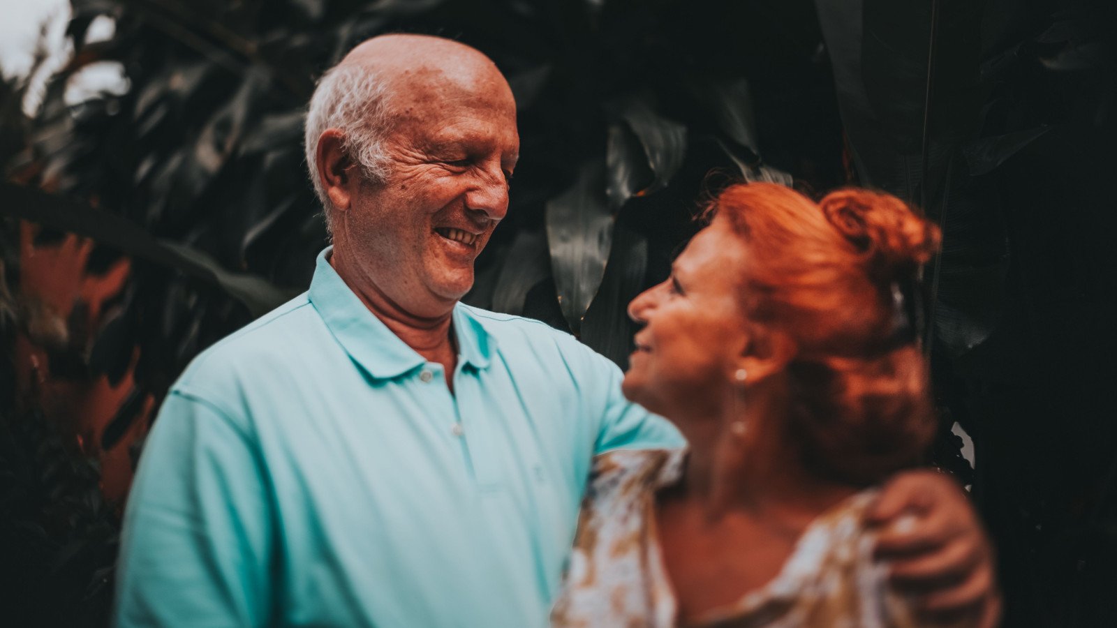 Senior couple in a lush outdoor setting, representing the active-ageing lifestyle positioning of IKIGAI Goa senior living at Kadamba Plateau, North Goa