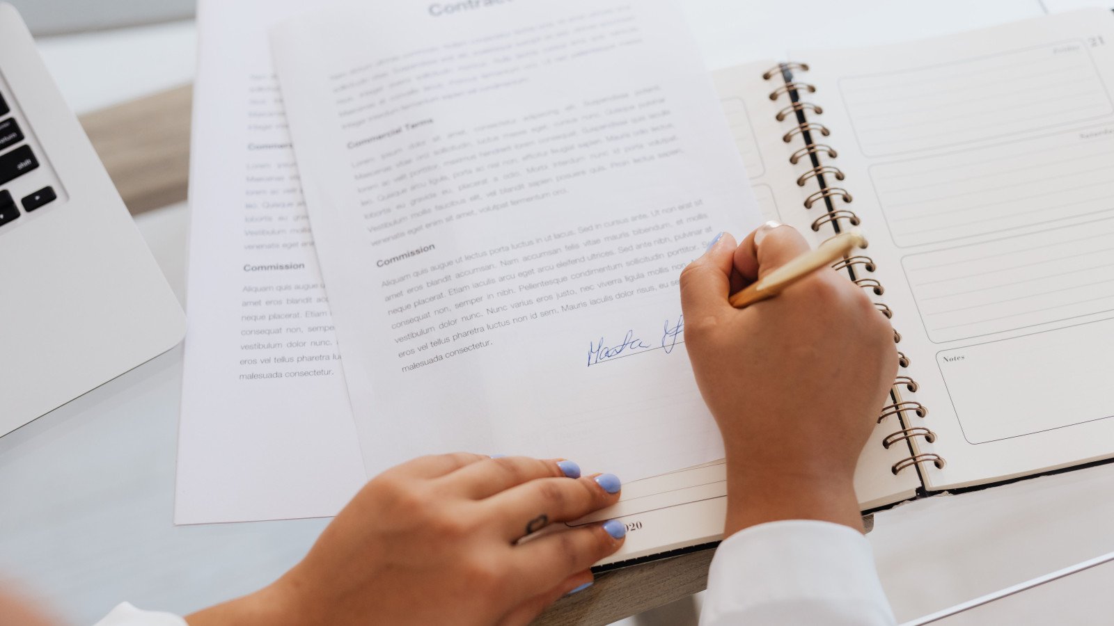 Hands signing a property document, representing mother deed and chain-of-title verification before a resale property transaction in Delhi-NCR.